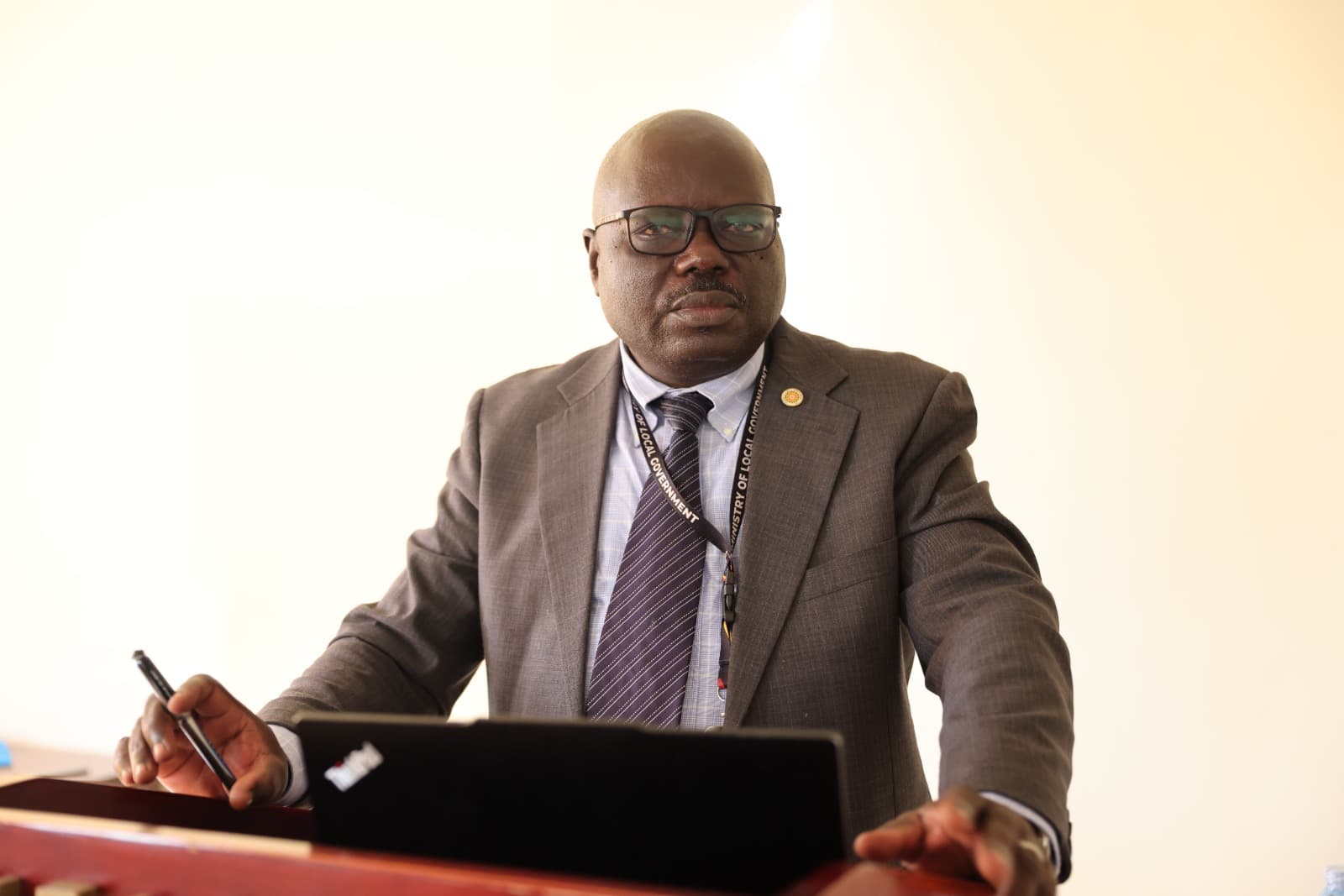 Commissioner for District Inspection, Mr. Idha Stephen Koma, representing the Permanent Secretary, Ben Kumumanya, officially opens the Review Workshop on the LG Compliance Inspection Manual